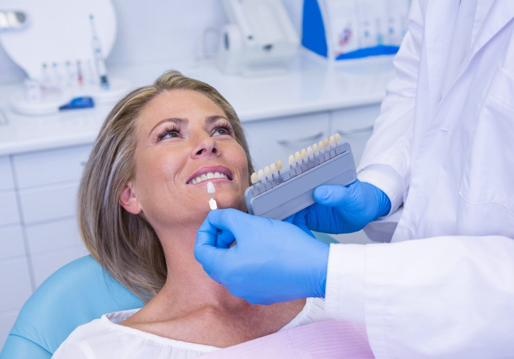 doctor-holding-tooth-whitening-equipment-by-patient.jpg doctor-holding-tooth-whitening-equipment-by-patient.jpg